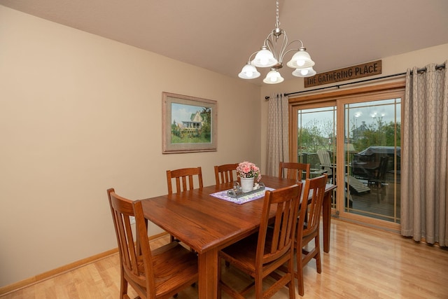 420 Cedar Ct NE, Pine Island, MN 55963 - dining room with light wood-style floors, a chandelier, and baseboards