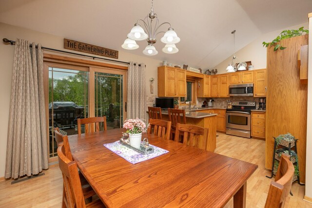 420 Cedar Ct NE, Pine Island, MN 55963 - dining space with a chandelier, light wood finished floors, and lofted ceiling