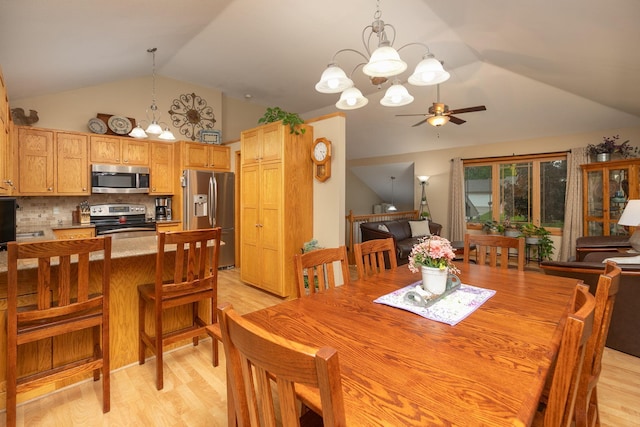 420 Cedar Ct NE, Pine Island, MN 55963 - dining area with light wood-style floors, a chandelier, a ceiling fan, and high vaulted ceiling