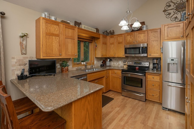420 Cedar Ct NE, Pine Island, MN 55963 - kitchen featuring appliances with stainless steel finishes, a sink, lofted ceiling, backsplash, and a peninsula