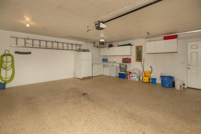 420 Cedar Ct NE, Pine Island, MN 55963 - garage with freestanding refrigerator and a garage door opener