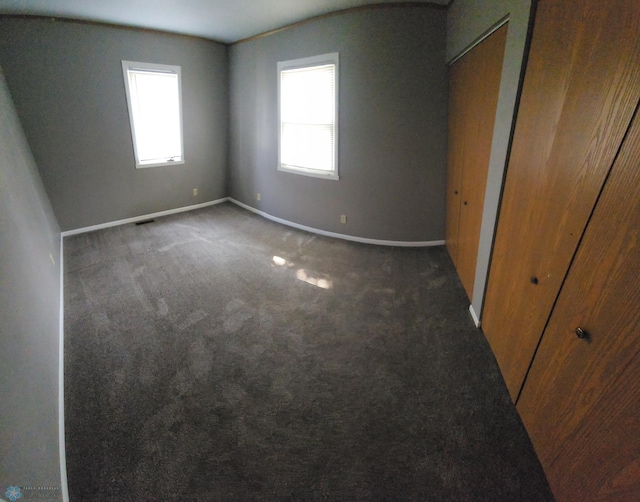 1033 27th St N, Fargo, ND 58102 - unfurnished bedroom with baseboards and carpet flooring