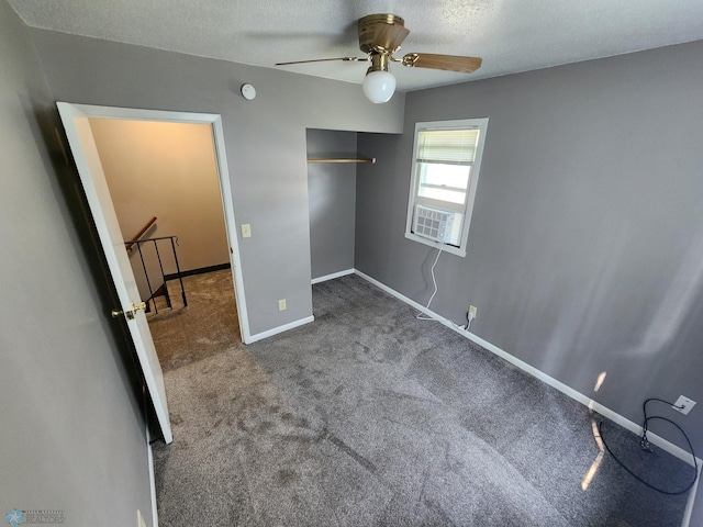 1033 27th St N, Fargo, ND 58102 - unfurnished bedroom featuring carpet flooring, a closet, baseboards, a ceiling fan, and a textured ceiling