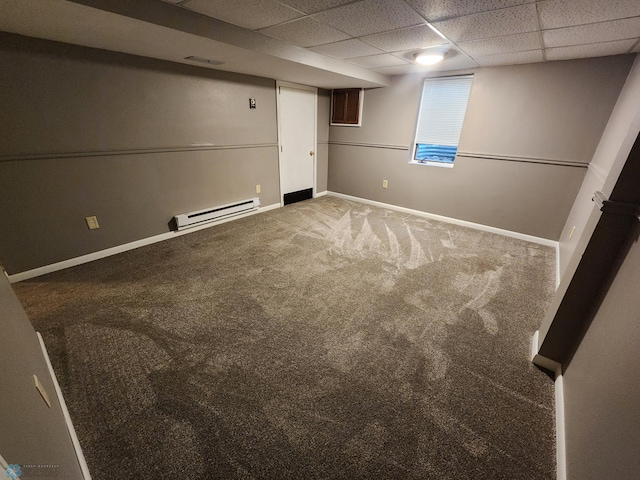 1033 27th St N, Fargo, ND 58102 - finished below grade area featuring a baseboard radiator, carpet flooring, baseboards, and a paneled ceiling