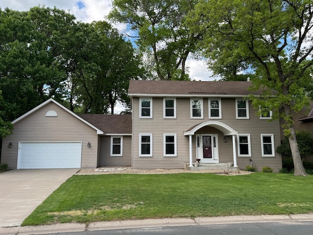 13545 Glasgow Ln, Apple Valley, MN 55124 - colonial home featuring an attached garage, concrete driveway, a front yard, and a shingled roof