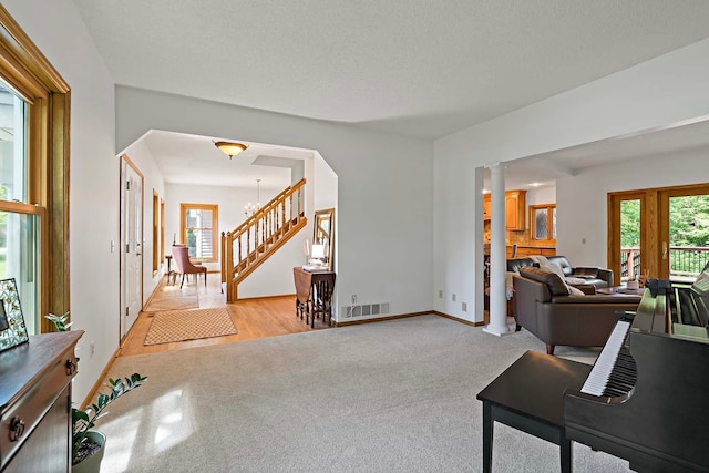13545 Glasgow Ln, Apple Valley, MN 55124 - entrance foyer with light carpet, healthy amount of natural light, ornate columns, and baseboards