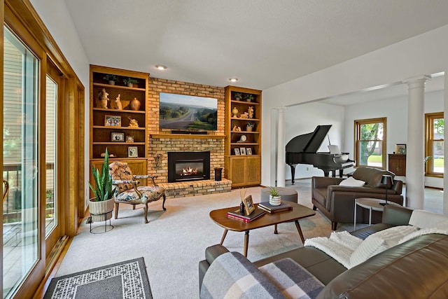 13545 Glasgow Ln, Apple Valley, MN 55124 - living area with built in shelves, decorative columns, carpet flooring, and a fireplace