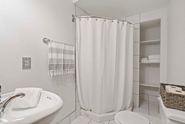 13545 Glasgow Ln, Apple Valley, MN 55124 - full bath featuring toilet, a sink, a stall shower, and tile patterned flooring