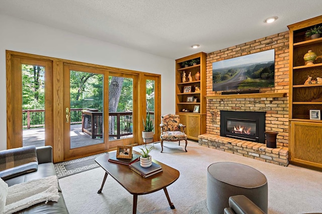 13545 Glasgow Ln, Apple Valley, MN 55124 - living room featuring built in features, a textured ceiling, a fireplace, and carpet