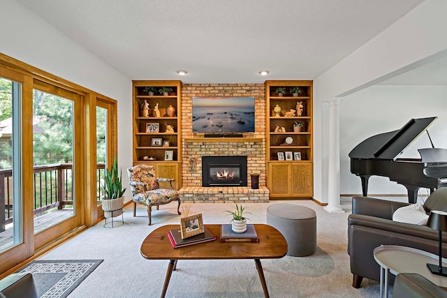 13545 Glasgow Ln, Apple Valley, MN 55124 - carpeted living room featuring decorative columns, built in shelves, a fireplace, a textured ceiling, and baseboards