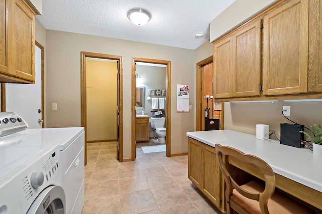 13545 Glasgow Ln, Apple Valley, MN 55124 - laundry room with cabinet space, washer and dryer, an office area, light tile patterned floors, and a textured ceiling