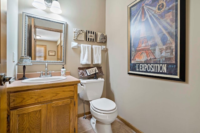 13545 Glasgow Ln, Apple Valley, MN 55124 - bathroom featuring toilet, vanity, tile patterned flooring, and baseboards