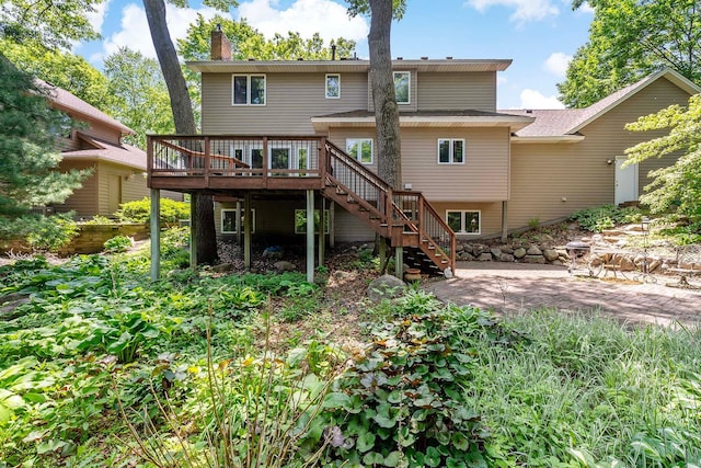 13545 Glasgow Ln, Apple Valley, MN 55124 - back of property featuring stairs, a wooden deck, and a chimney