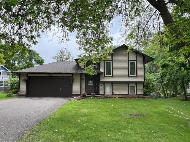 7196 Sunnyslope Dr, Maple Grove, MN 55311 - split level home featuring asphalt driveway, a front lawn, and a garage