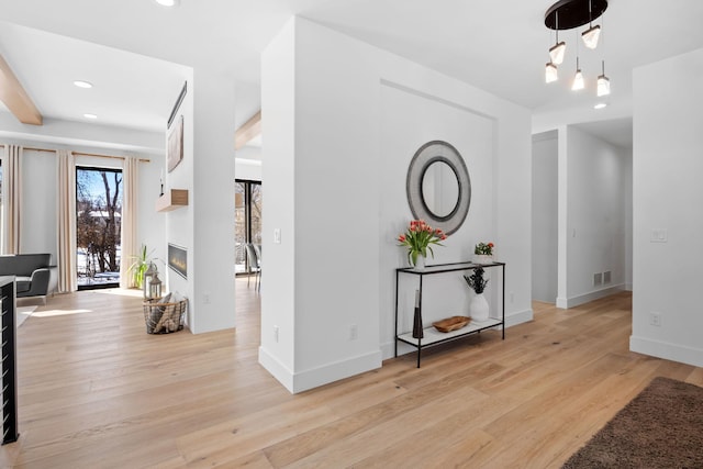 16216 Gleason Lake Rd, Minnetonka, MN 55391 - foyer featuring light wood-type flooring, a glass covered fireplace, recessed lighting, and baseboards