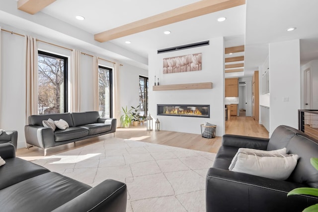 16216 Gleason Lake Rd, Minnetonka, MN 55391 - living room with plenty of natural light, light wood-type flooring, a glass covered fireplace, and recessed lighting