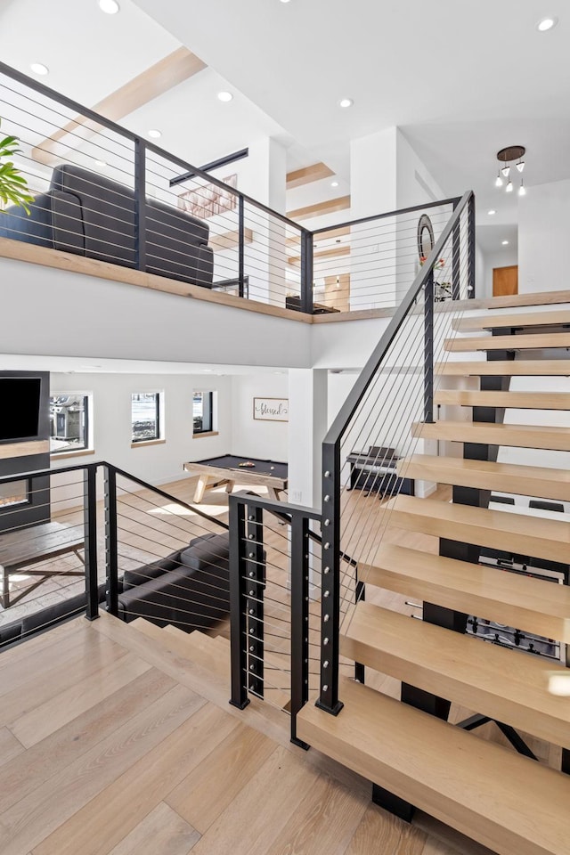 16216 Gleason Lake Rd, Minnetonka, MN 55391 - stairs featuring wood finished floors, recessed lighting, and a high ceiling