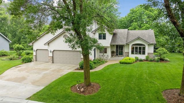 1378 Dunsmore Dr, Waconia, MN 55387 - view of front of house featuring stone siding, stucco siding, concrete driveway, and a front yard