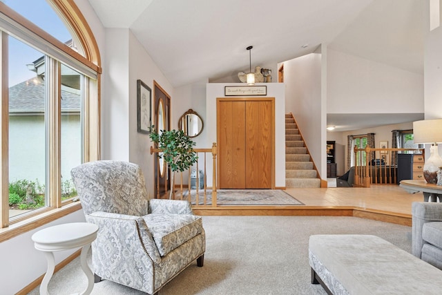 1378 Dunsmore Dr, Waconia, MN 55387 - carpeted living area featuring lofted ceiling, stairs, and baseboards
