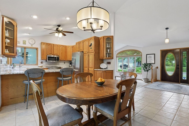 1378 Dunsmore Dr, Waconia, MN 55387 - dining area featuring lofted ceiling, light tile patterned floors, and a ceiling fan
