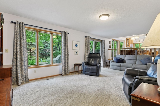 1378 Dunsmore Dr, Waconia, MN 55387 - carpeted living area featuring a textured ceiling, baseboards, and a chandelier