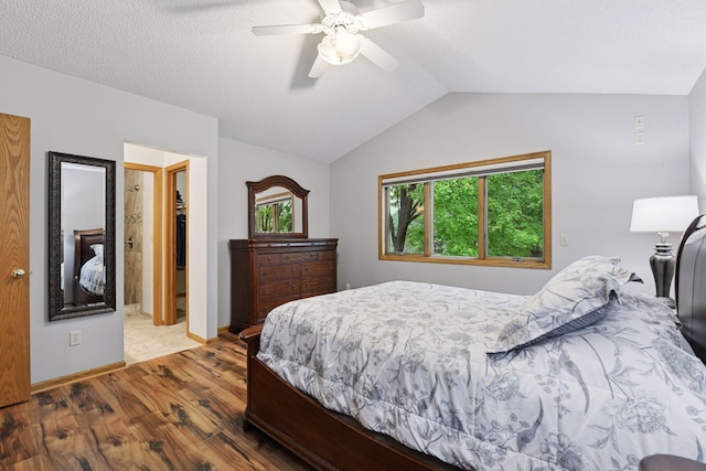 1378 Dunsmore Dr, Waconia, MN 55387 - bedroom featuring wood finished floors, vaulted ceiling, a walk in closet, a ceiling fan, and baseboards