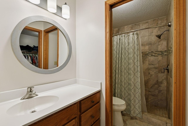 1378 Dunsmore Dr, Waconia, MN 55387 - full bathroom featuring toilet, tiled shower, vanity, a textured ceiling, and a walk in closet