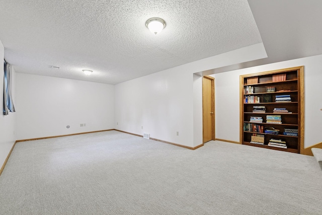 1378 Dunsmore Dr, Waconia, MN 55387 - below grade area with baseboards, a textured ceiling, carpet flooring, and built in features