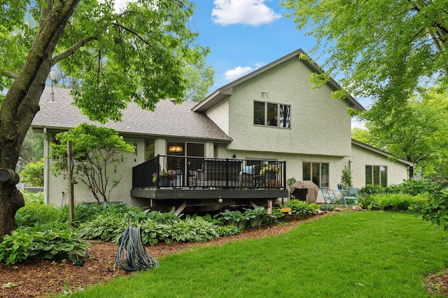 1378 Dunsmore Dr, Waconia, MN 55387 - rear view of property with stucco siding, a yard, a wooden deck, and a shingled roof