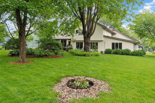 1378 Dunsmore Dr, Waconia, MN 55387 - rear view of property with stucco siding and a lawn