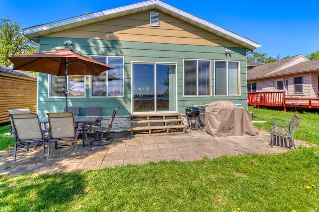 25934 Brolin Beach Rd, Detroit Twp, MN 56501 - back of property with entry steps, a patio, and a lawn