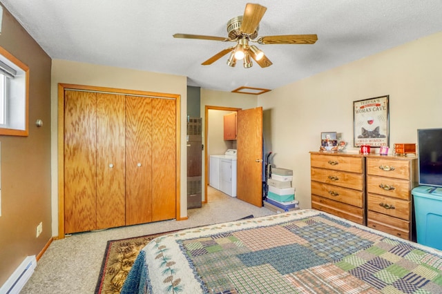25934 Brolin Beach Rd, Detroit Twp, MN 56501 - bedroom featuring a baseboard heating unit, washing machine and clothes dryer, a closet, light colored carpet, and baseboards