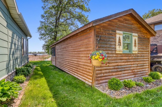 25934 Brolin Beach Rd, Detroit Twp, MN 56501 - view of home's exterior featuring an outbuilding, a lawn, and log veneer siding