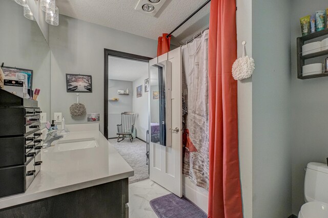 17690 Clayton Ave E, Vermillion Twp, MN 55068 - full bathroom featuring marble finish flooring, toilet, double vanity, and a textured ceiling