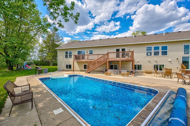 17690 Clayton Ave E, Vermillion Twp, MN 55068 - view of swimming pool featuring stairs, a wooden deck, a patio, a covered pool, and a playground