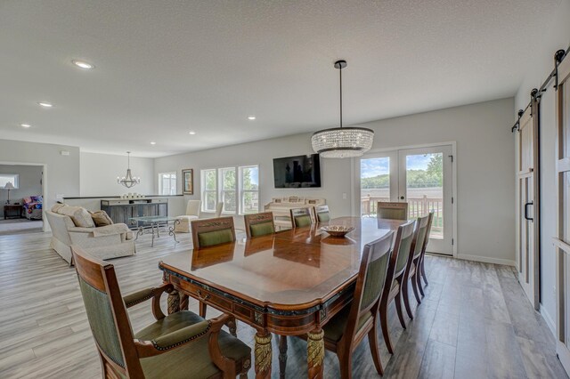 17690 Clayton Ave E, Vermillion Twp, MN 55068 - dining room featuring a chandelier, a barn door, light wood finished floors, healthy amount of natural light, and recessed lighting