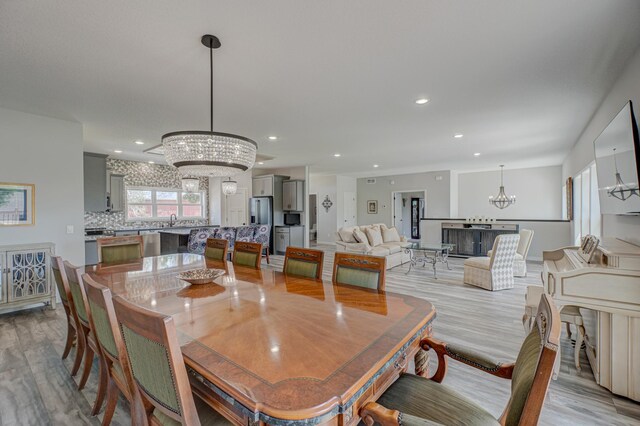 17690 Clayton Ave E, Vermillion Twp, MN 55068 - dining space featuring a chandelier, light wood finished floors, and recessed lighting