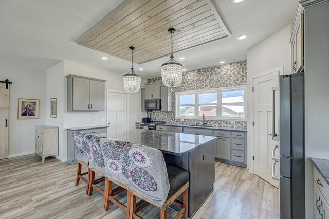 17690 Clayton Ave E, Vermillion Twp, MN 55068 - kitchen with freestanding refrigerator, gray cabinets, gas range, a sink, and recessed lighting