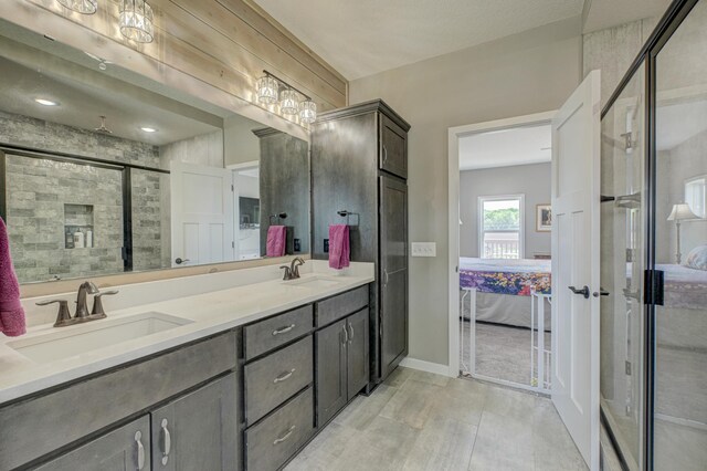 17690 Clayton Ave E, Vermillion Twp, MN 55068 - ensuite bathroom featuring double vanity, a shower stall, and baseboards