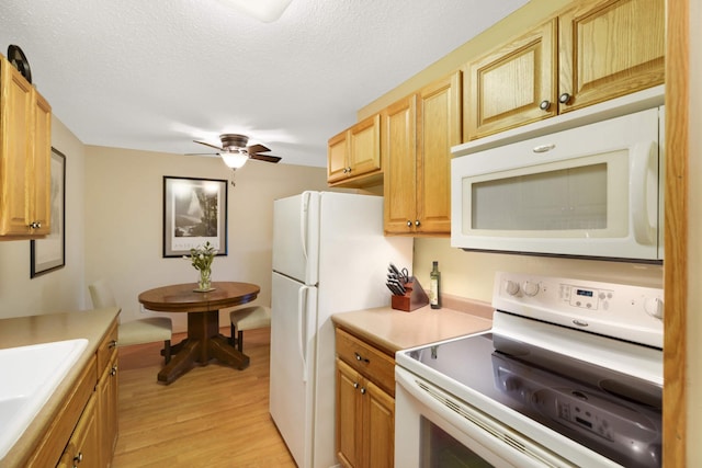 3461 Kent St Unit 1104, Shoreview, MN 55126 - kitchen with white appliances, light wood-style flooring, a ceiling fan, light countertops, and a sink