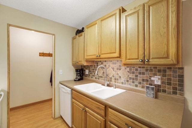 3461 Kent St Unit 1104, Shoreview, MN 55126 - kitchen with dishwasher, a sink, light wood finished floors, backsplash, and a textured ceiling
