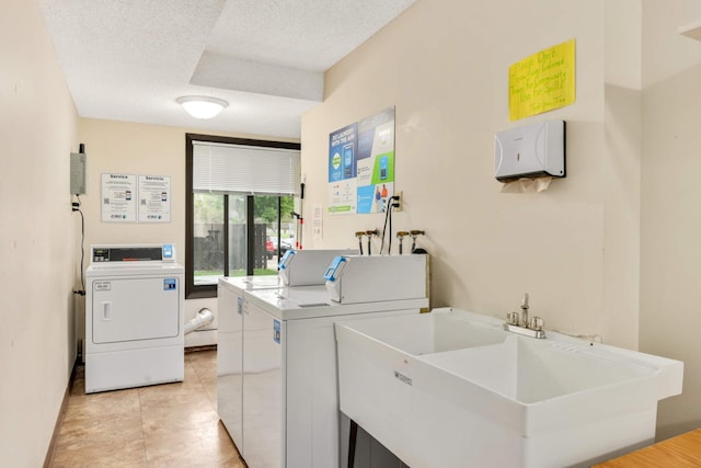 3461 Kent St Unit 1104, Shoreview, MN 55126 - shared laundry room featuring washing machine and dryer, a textured ceiling, and light tile patterned floors