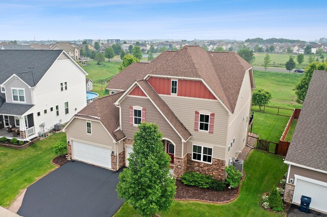 14111 Abercorn Ave, Rosemount, MN 55068 - view of front facade featuring stone siding, board and batten siding, asphalt driveway, central air condition unit, and roof with shingles
