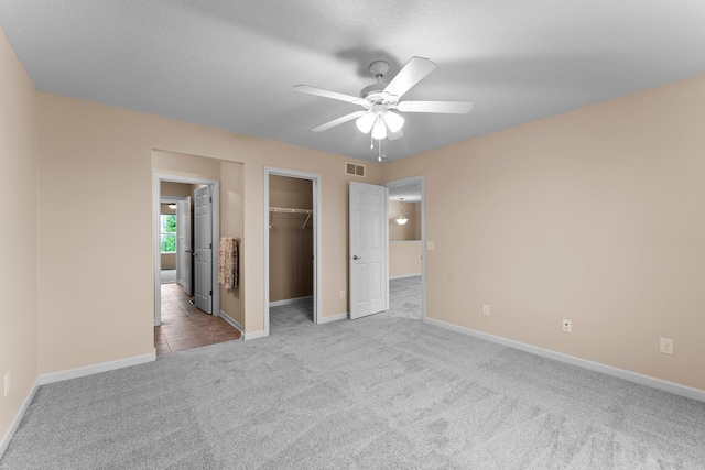 14111 Abercorn Ave, Rosemount, MN 55068 - unfurnished bedroom with carpet flooring, baseboards, a walk in closet, a closet, and ceiling fan