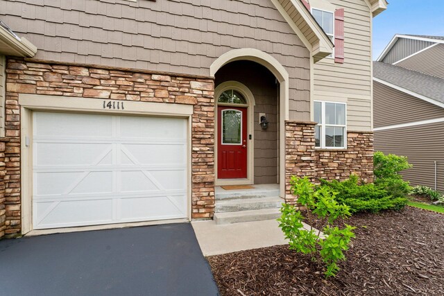14111 Abercorn Ave, Rosemount, MN 55068 - entrance to property featuring stone siding, a garage, and driveway