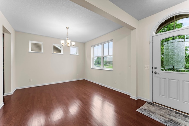 14111 Abercorn Ave, Rosemount, MN 55068 - entryway featuring a chandelier, dark wood-style flooring, and baseboards
