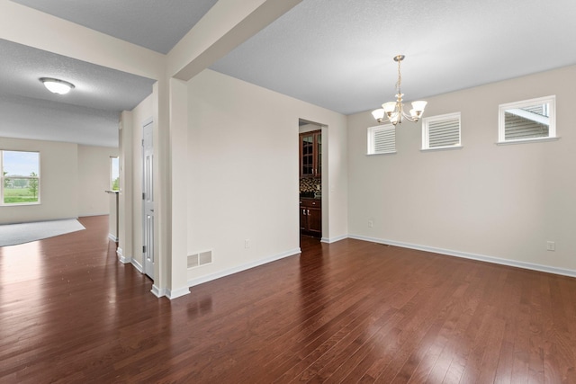 14111 Abercorn Ave, Rosemount, MN 55068 - unfurnished room with a chandelier, dark wood-style flooring, and baseboards