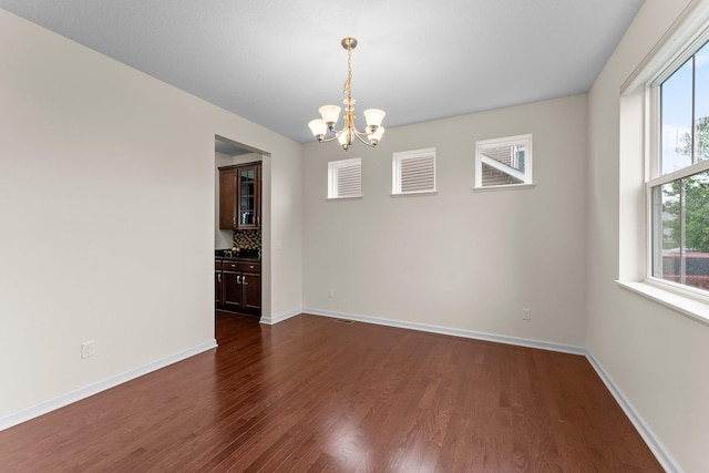 14111 Abercorn Ave, Rosemount, MN 55068 - unfurnished room featuring a chandelier, dark wood-style floors, and baseboards