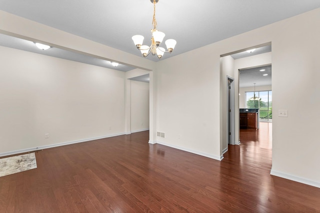 14111 Abercorn Ave, Rosemount, MN 55068 - unfurnished room with a chandelier, dark wood finished floors, and baseboards