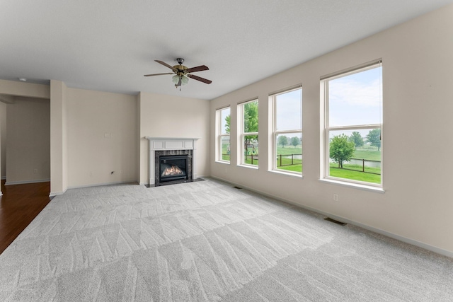 14111 Abercorn Ave, Rosemount, MN 55068 - unfurnished living room featuring a fireplace with flush hearth, carpet floors, a ceiling fan, and baseboards